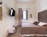 ferienwohnung-dimora-braunes-schlafzimmer.jpg
