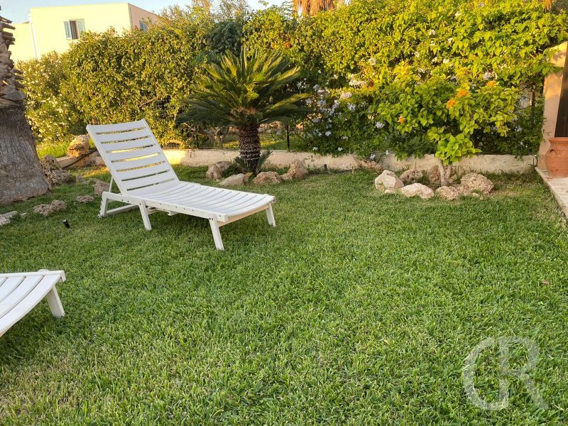 ferienhaus-grecale-garten-mit-sonnenliegen.jpg