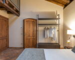 villa-continella-seitliche-ansicht-schlafzimmer-mit-holzdecken-und-galerie.jpg